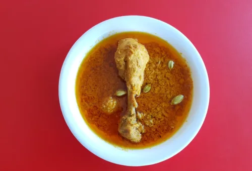 A bowl of soup on a red table